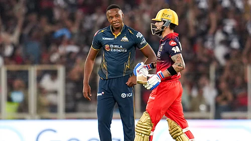 PTI : Kagiso Rabada (left) and Virat Kohli in action during the Indian Premier League match between Gujarat Titans and Royal Challengers Bengaluru in Ahmedabad.