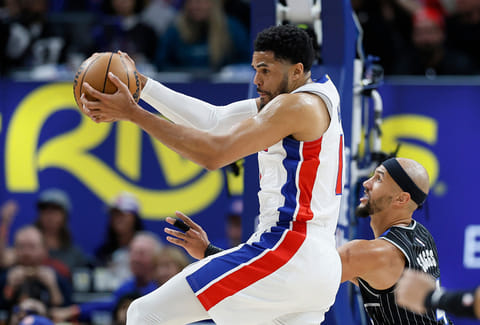 Detroit Pistons forward Tobias Harris, left, grabs a defensive rebound against Orlando Magic guard Jalen Suggs, right, during the first half in Game 5 of a first-round NBA basketball playoffs series in Detroit. 