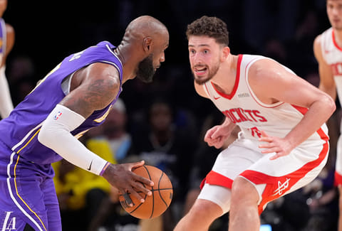 Los Angeles Lakers forward LeBron James, left, tries to get by Houston Rockets center Alperen Sengun during the second half in Game 5 of a first-round NBA playoffs basketball series in Los Angeles.