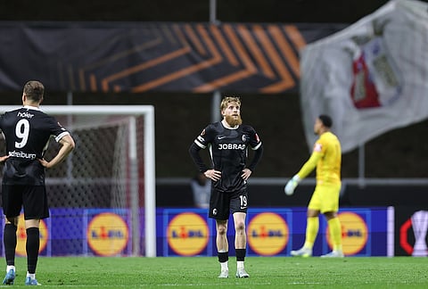 Freiburg's Jan-Niklas Beste reacts after Braga's Mario Dorgeles scored his side's second goal during the Europa League semifinal, first leg, soccer match between SC Braga and Freiburg in Braga, Portugal.