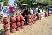 | Photo: PTI : A vendor arranges clay pots for sale on a hot summer day, in Bikaner, Rajasthan.