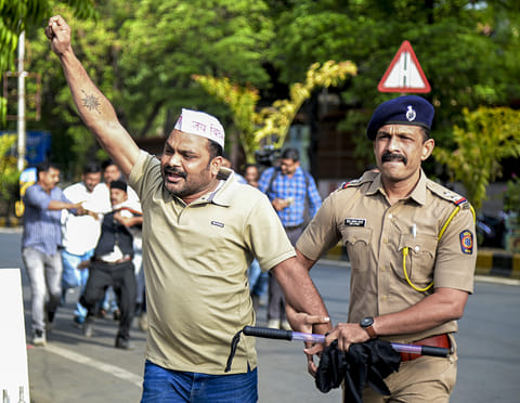 Police detain a member of the Vidarbha Rajya Andolan Samiti (VRAS) after they staged a protest demanding a separate Vidarbha state on Maharashtra Day, in Nagpur.
