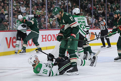 Minnesota Wild left wing Marcus Foligno (17) stands over Dallas Stars center Oskar Bäck (10) during the second period of Game 6 in the first round of the NHL hockey Stanley Cup playoff series in St. Paul, Minnesota. 