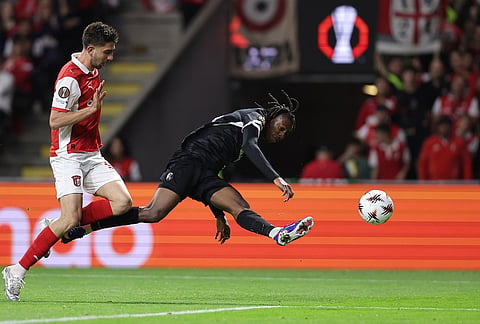 Freiburg's Jordy Makengo crosses the ball past Braga's Demir Ege Tıknaz, left, during the Europa League semifinal, first leg, soccer match between SC Braga and Freiburg in Braga, Portugal.