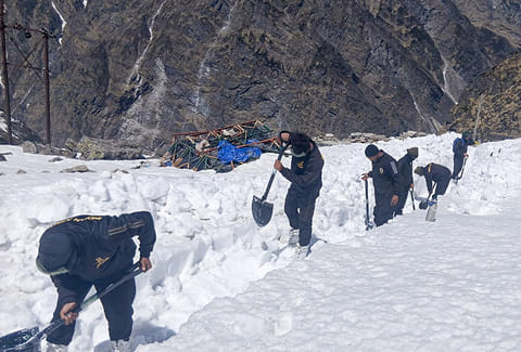 Army personnel clear snow from the premises of Gurudwara Hemkunt Sahib ahead of its portal opening ceremony, scheduled to be on May 23rd, in Chamoli district, Uttarakhand.