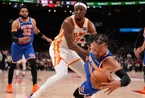 New York Knicks guard Jalen Brunson (11) and Atlanta Hawks forward Onyeka Okongwu (17) fight for the ball in the first half during Game 6 in a first-round NBA basketball playoffs series in Atlanta. 