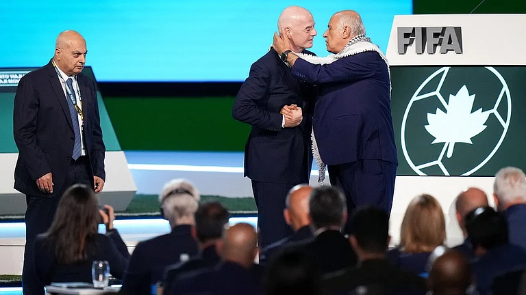 Palestinian Football Association president Jibril Rajoub, right, reaches to kiss FIFA president Gianni Infantino on the cheek after speaking as Israel Football Association vice-president Basim Sheikh Suliman, left, watches during the 76th FIFA Congress in Vancouver, British Columbia. - Darryl Dyck/The Canadian Press via AP