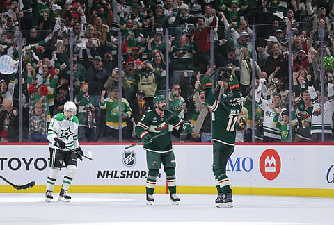 Minnesota Wild left wing Matt Boldy (12) celebrates with defenseman Jake Middleton (5) after scoring his second goal during the third period of Game 6 in the first round of the NHL hockey Stanley Cup playoff series against the Dallas Stars, in St. Paul, Minnesota.