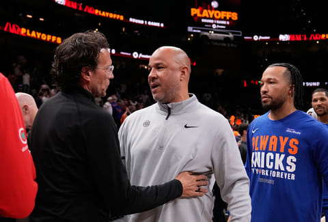 New York Knicks assistant coach Rick Brunson and Atlanta Hawks head coach Quin Snyder meet after Game 6 in a first-round NBA basketball playoffs series in Atlanta. 