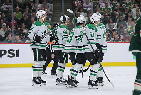 Dallas Stars center Wyatt Johnston (53) celebrates with teammates after scoring on Minnesota Wild goaltender Jesper Wallstedt during the second period of Game 6 in the first round of the NHL hockey Stanley Cup playoff series in St. Paul, Minnesota.