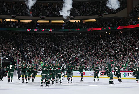 Minnesota Wild players celebrate after wining Game 6 in the first round of the NHL hockey Stanley Cup playoff series against the Dallas Stars, in St. Paul, Minnesota.