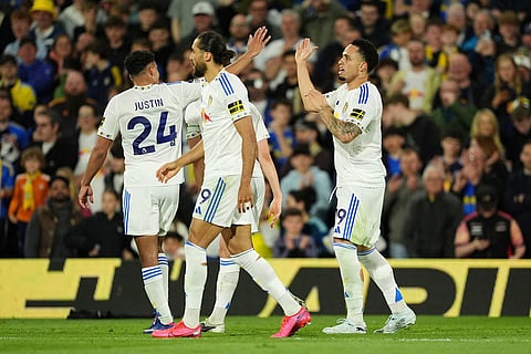 Leeds United's Noah Okafor, right, celebrates with teammates after scoring their side's second goal during the Premier League match between Leeds United and Burnley, in Leeds, England.