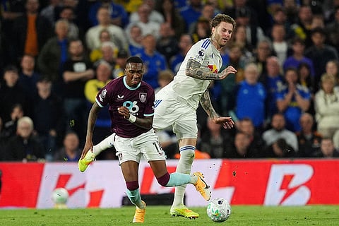 Burnley's Jaidon Anthony, left, and Leeds United's Joe Rodon battle for the ball  during the Premier League match between Leeds United and Burnley, in Leeds, England.