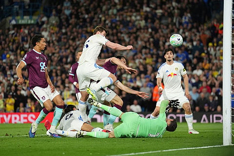 Leeds United's Dominic Calvert-Lewin, second from left, scores their side's third goal  during the Premier League match between Leeds United and Burnley, in Leeds, England.