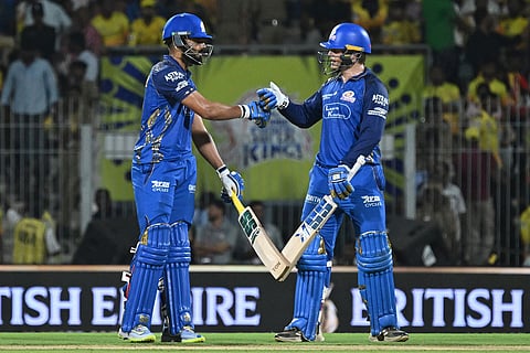 Mumbai Indians' Ryan Rickelton, right, and batting partner Naman Dhir touch gloves during the Indian Premier League cricket match between Chennai Super Kings and Mumbai Indians in Chennai, India.