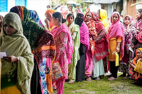 Voters wait in queues to cast their votes at a polling station during a repoll ordered by the Election Commission following reports of electoral malpractices, at Magrahat Paschim constituency, in South 24 Parganas district, West Bengal.