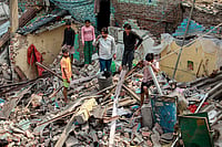 | PTI Photo : New Delhi: People gather at a demolished structure after an anti encroachment drive was carried out by Municipal Corporation of Delhi (MCD) at Wazirpur industrial area, in New Delhi.