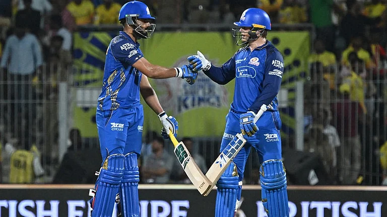 Mumbai Indians' Ryan Rickelton, right, and batting partner Naman Dhir touch gloves during the Indian Premier League cricket match between Chennai Super Kings and Mumbai Indians in Chennai, India. - | Photo: AP