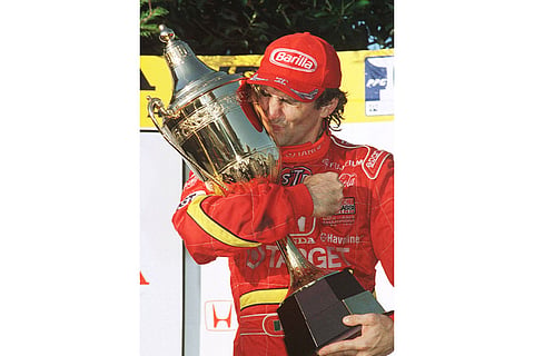 Italian driver Alex Zanardi kisses the winners trophy at the Australian Indy Car race in Surfers Paradise, Queensland.