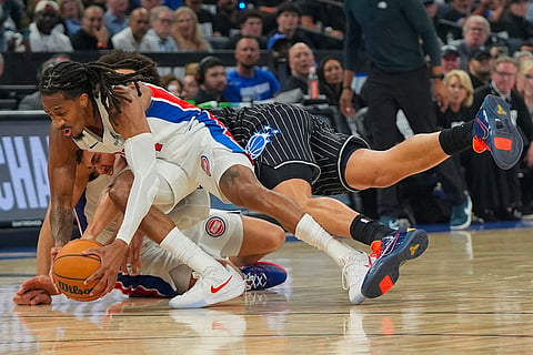 Detroit Pistons guard Daniss Jenkins, left, fights for a loose ball with Orlando Magic forward Tristan da Silva during the second half in Game 6 of a first-round NBA basketball playoffs series in Orlando, Fla.