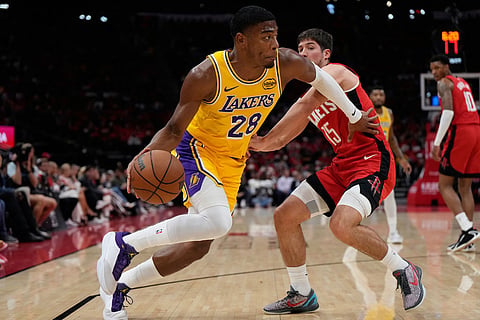 Los Angeles Lakers forward Rui Hachimura (28) controls the ball against Houston Rockets guard Reed Sheppard (15) during the first half of Game 6 of a first-round NBA playoffs basketball series in Houston.
