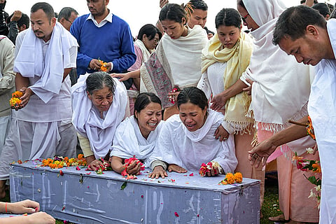 Bereaved family members and relatives perform the last rites of two children, who were killed in a bomb attack in April, amid rainfall, in Bishnupur district, Manipur. The bodies of the five-year-old boy and his six-month-old sister were kept in the morgue for 25 days, as the family members had refused to accept the mortal remains, demanding that the perpetrators be brought to book at the earliest.