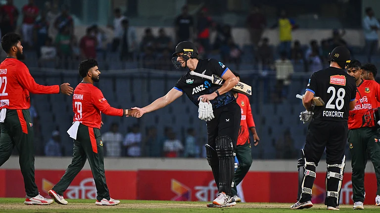 New Zealand's Bevon Jacobs shakes hands with Bangladesh's players after winning the third T20 international cricket match between Bangladesh and New Zealand in Mirpur, Bangladesh, Saturday, May 2, 2026 - (AP Photo/Mosaraf Hossain)
