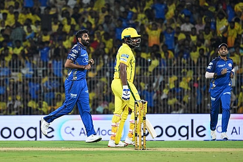 Mumbai Indians' Jasprit Bumrah, left, celebrates the wicket of Chennai Super Kings' Sanju Samson, center, during the Indian Premier League cricket match between Chennai Super Kings and Mumbai Indians in Chennai, India.