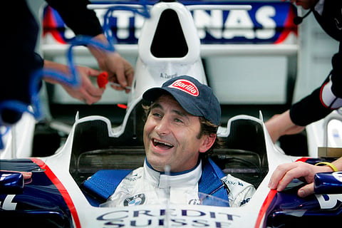 Two-time CART champion Alex Zanardi, who lost both of his legs in a horrific crash in 2001, smiles from inside the modified cockpit of his BMW-Sauber C24-B after his historic drive, as he becomes the first double amputee to test drive a Formula One car in the Cheste racetrack near Valencia, Spain.