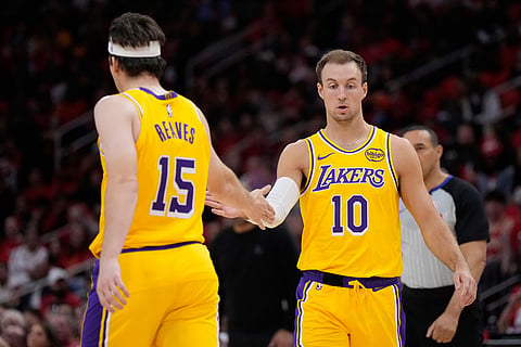 Los Angeles Lakers guard Austin Reaves (15) celebrates with guard Luke Kennard (10) during the first half of Game 6 of a first-round NBA playoffs basketball series against the Houston Rockets in Houston,