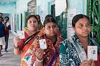 In Photos: West Bengal Repoll Draws Steady Voter Turnout | Photo: PTI/Swapan Mahapatra : Voters shows their identity cards as they wait in a queue to cast their votes at a polling station during a repoll ordered by the Election Commission following reports of electoral malpractices, at Magrahat Paschim constituency, in South 24 Parganas district, West Bengal.