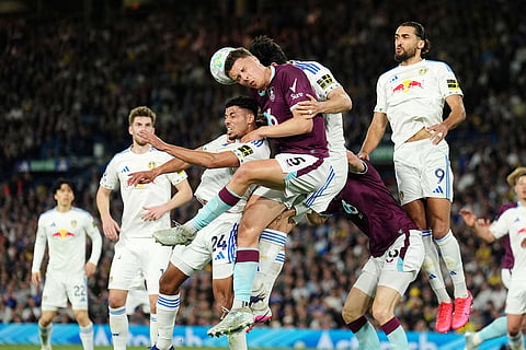 Burnley's Maxime Esteve, centre left, and Leeds United's Pascal Struijk challenge for the ball during the Premier League match between Leeds United and Burnley, in Leeds, England.