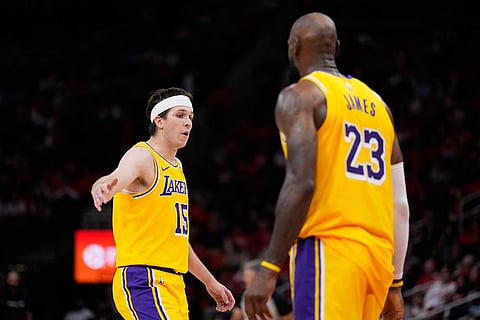 Los Angeles Lakers guard Austin Reaves (15) celebrates with forward LeBron James (23) during the second half of Game 6 of a first-round NBA playoffs basketball series against the Houston Rockets in Houston.