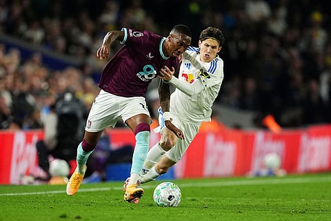 Burnley's Jaidon Anthony, left, and Leeds United's Brenden Aaronson battle for the ball during the English Premier League soccer match between Leeds United and Burnley in Leeds, England.
