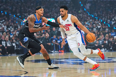 Detroit Pistons forward Tobias Harris (12) drives against Orlando Magic forward Paolo Banchero (5) during the first half in Game 6 of a first-round NBA basketball playoffs series, in Orlando, Fla.