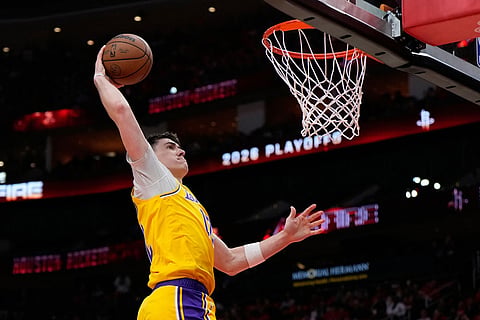 Los Angeles Lakers forward Jake LaRavia dunks during the first half of Game 6 of a first-round NBA playoffs basketball series against the Houston Rockets in Houston.