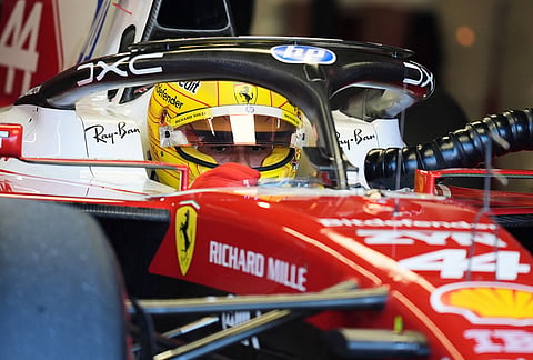 Ferrari driver Lewis Hamilton of Britain sits in his car during the qualifying session of the of the Miami Formula One Grand Prix auto race in Miami Gardens, Florida.