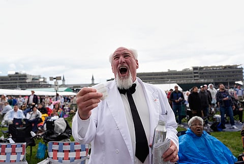 Bob Dean reacts after winning his bet on a race before the 152nd running of the Kentucky Derby horse race at Churchill Downs, in Louisville, Kentucky.