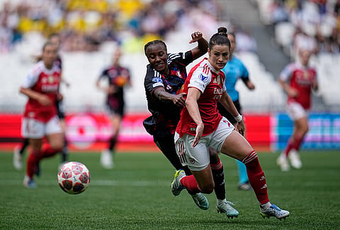 Arsenal's Emily Fox, right, vies for the ball with Lyonnes' Vicki Becho during the Women's Champions League semifinal, second leg, soccer match between OL Lyonnes and Arsenal, in Decines, outside Lyon, France.