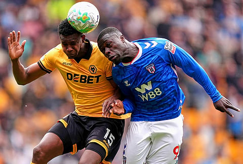 Wolverhampton Wanderers' Yerson Mosquera, left, and Sunderland's Brian Brobbey battle for the ball during their English Premier League soccer match in Wolverhampton, England.