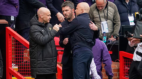Liverpool's manager Arne Slot, centre right, greets Manchester United's head coach Michael Carrick ahead of the English Premier League soccer match between Manchester United and Liverpool in Manchester, England, Sunday, May 3, 2026