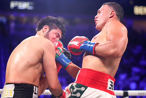 David Benavidez punches Gilberto Ramirez in a cruiserweight championship boxing match in Las Vegas.