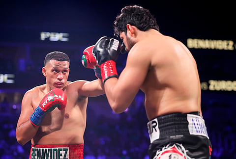 David Benavidez, left, and Gilberto Ramirez fight in a cruiserweight championship boxing match in Las Vegas. 