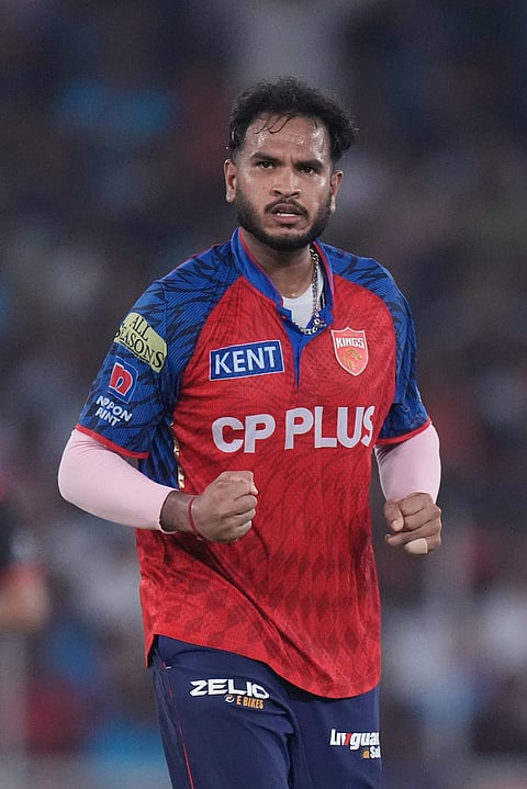 Punjab Kings' Vijaykumar Vyshak celebrates the wicket of Gujarat Titans' Jos Buttler during the Indian Premier League cricket match between Gujarat Titans and Punjab Kings in Ahmedabad.