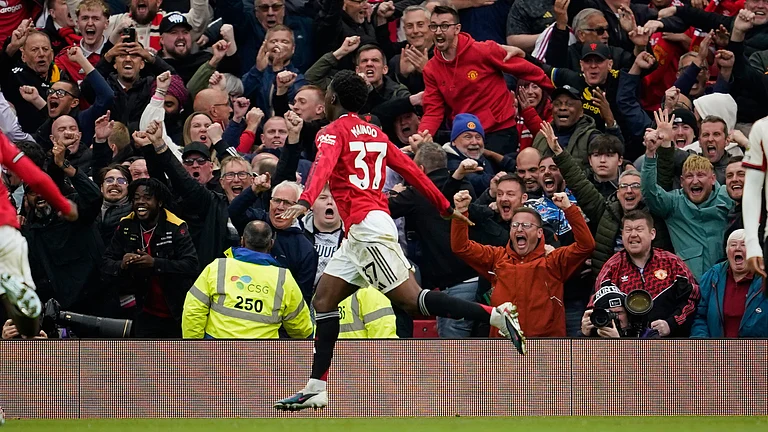 Manchester United's Kobbie Mainoo celebrates after scoring his side's third goal during the English Premier League soccer match between Manchester United and Liverpool in Manchester, England, Sunday, May 3, 2026. - | Photo: AP/Dave Thompson