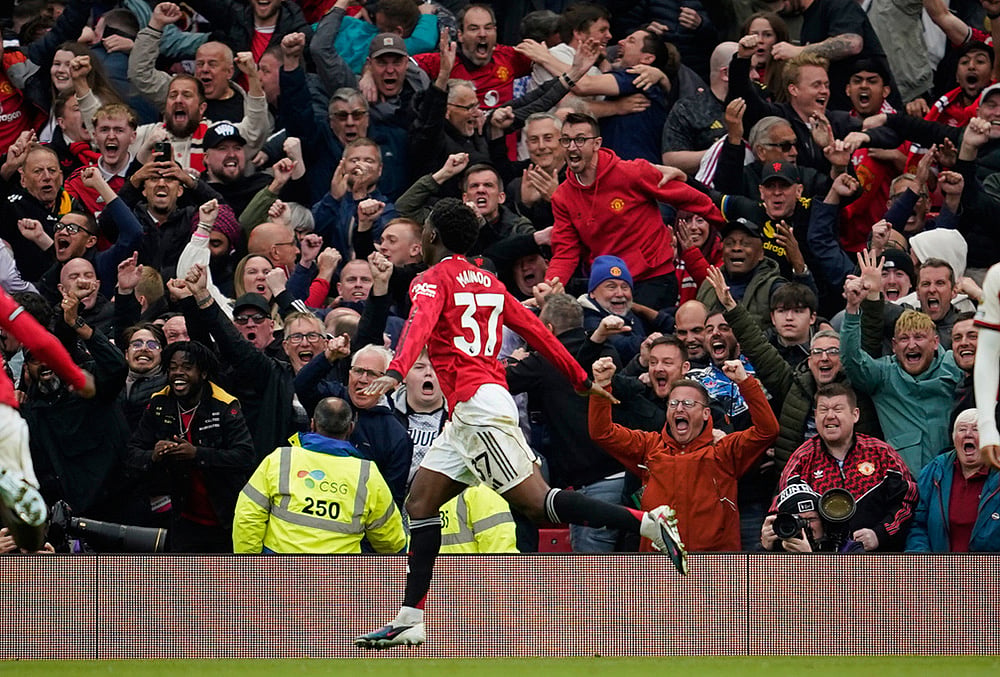 Manchester United's Kobbie Mainoo celebrates after scoring his side's third goal during the English Premier League soccer match between Manchester United and Liverpool in Manchester, England. - | Photo: AP/Dave Thompson