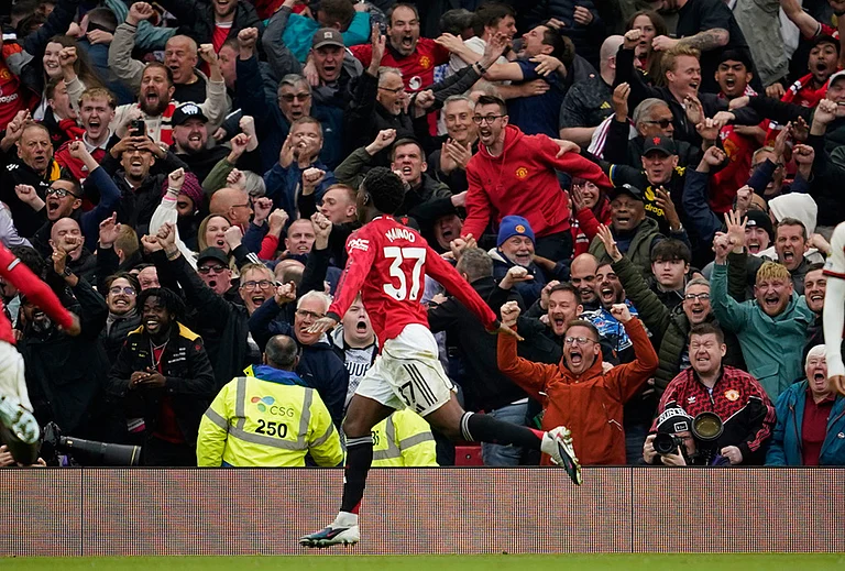 Manchester United's Kobbie Mainoo celebrates after scoring his side's third goal during the English Premier League soccer match between Manchester United and Liverpool in Manchester, England. - | Photo: AP/Dave Thompson