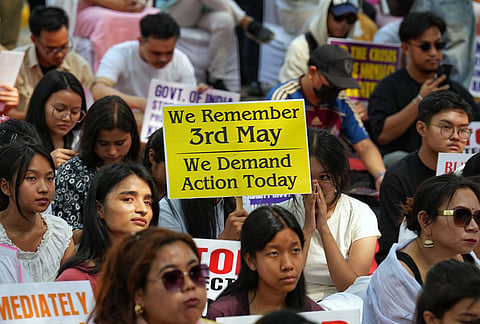 People hold placards during a protest on the third anniversary of the Manipur violence, at Jantar Mantar, in New Delhi.