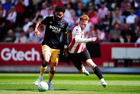 West Ham United's Pablo, left, and Brentford's Sepp van den Berg battle for the ball during their English Premier League soccer match in London.