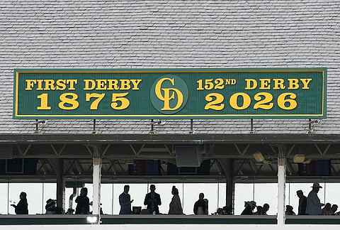 Fans stand under cover before the 152nd running of the Kentucky Derby horse race at Churchill Downs, in Louisville, Kentucky.